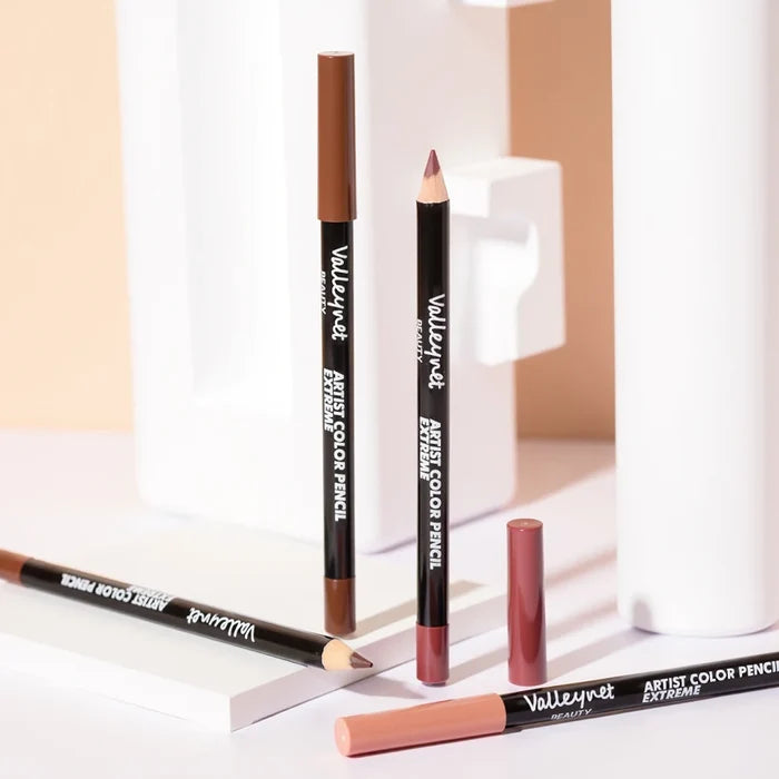 Set of four lip liner and eyeliner makeup pencils in black and nude shades, displayed on a neutral background.