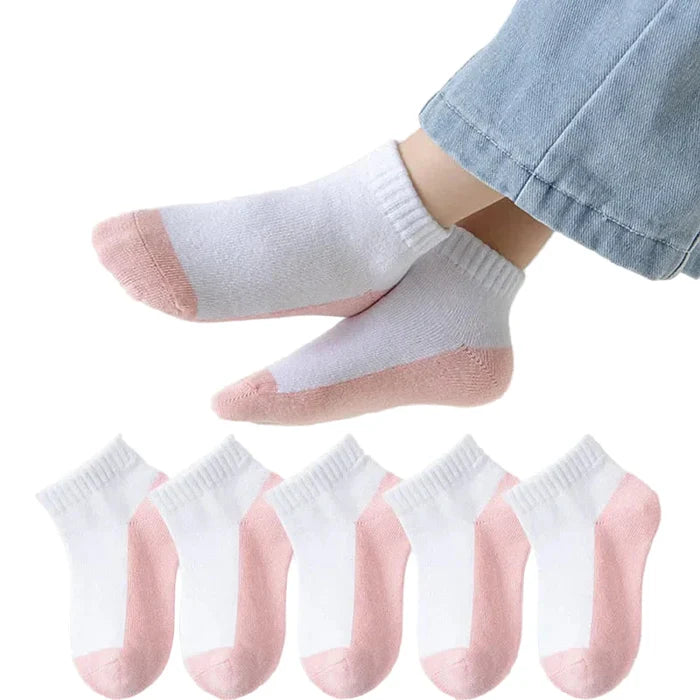 Five pairs of Habicare cotton socks for boys and girls aged 1 to 12, displayed in various colors on a plain background.
