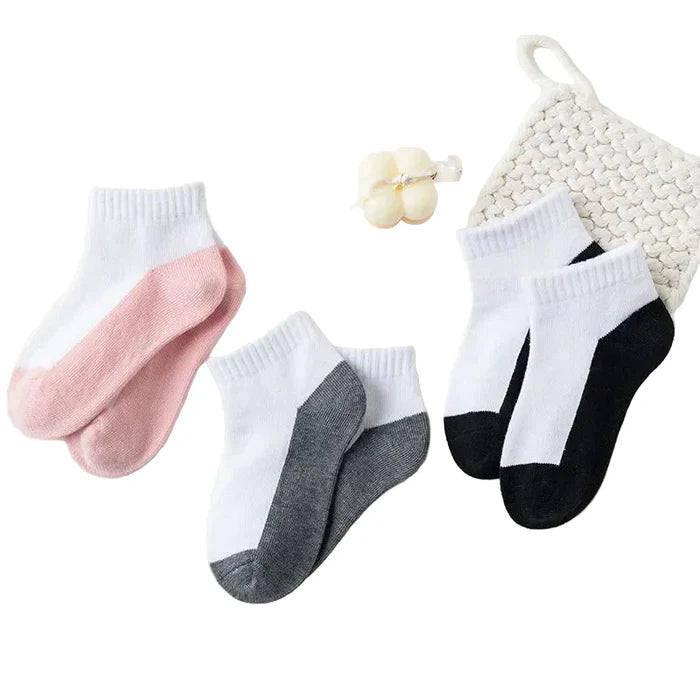 Five pairs of Habicare cotton socks for boys and girls aged 1 to 12, displayed in various colors and sizes on a plain background.