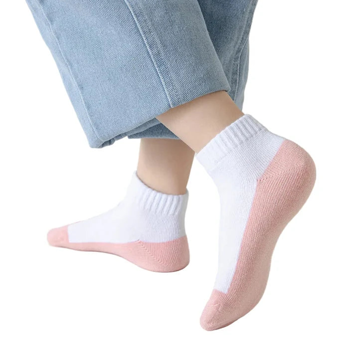 Five pairs of Habicare cotton socks for boys and girls aged 1 to 12, featuring colorful patterns and soft, breathable fabric.