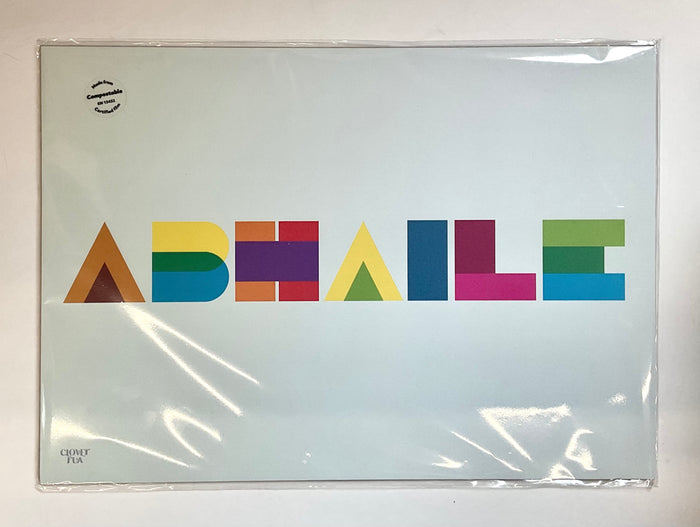 Colorful geometric lettering on a clear plastic cover with a white background