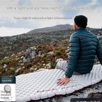 Mead's Supply & Equipment Outfitters air mattress mat spread out on a bedroom floor, showing its soft surface and compact design