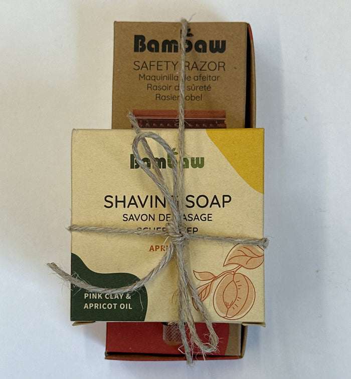 A boxed shaving soap product wrapped in twine, with the front label reading 'bamboo SHAVING SOAP' and 'PINK CYDDE & APRICOT OIL,' placed over a brown cardboard razor box on a white background.