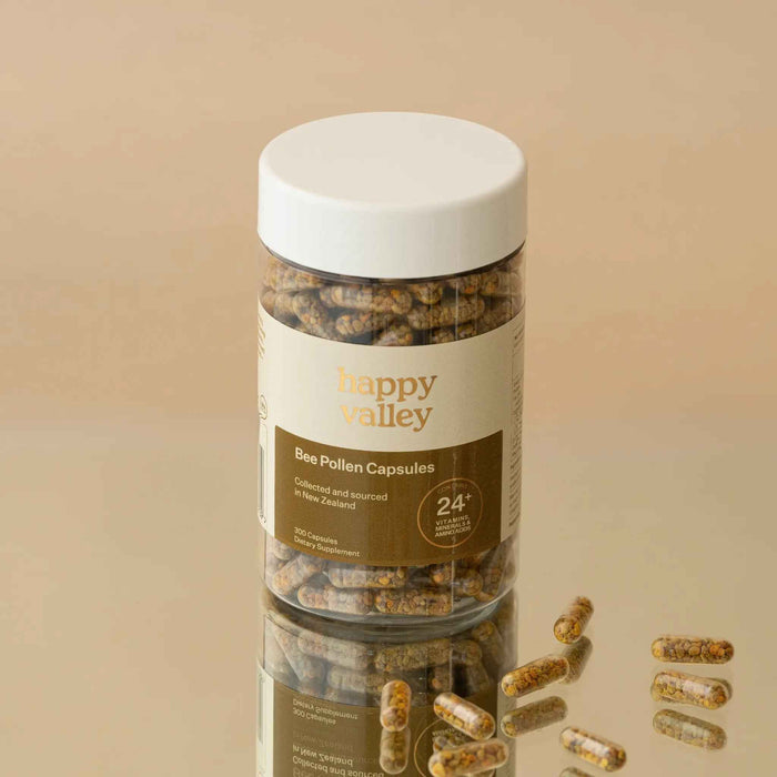 Close-up of Happy Valley Honey Bee Pollen Capsules 300, showing the smooth, yellow capsules in a clear container.