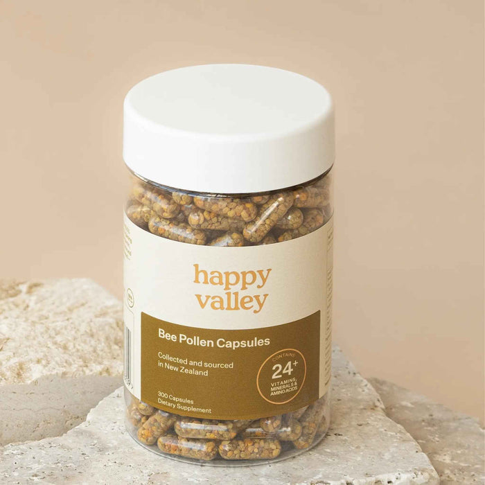 Two bottles of Happy Valley Honey Bee Pollen Capsules 300 with white labels and yellow caps, displayed on a white background.