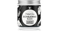 A jar of Ben & Anna Black Natural Care Toothpaste on a white background with a subtle reflection. The jar has a black label with white illustrations and a silver metal cap.