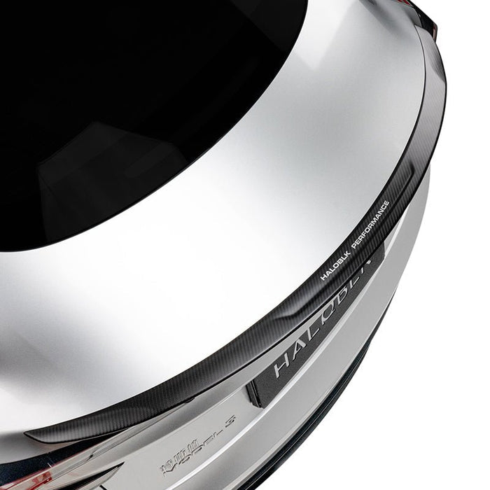 Close-up top view of a Tesla Model 3 Highland's rear, featuring the Carbon Fiber Rear Spoiler from HALOBLK Store with "MAJOLLY PERFORMANCE" lettering. The car's brand badge is partly visible at the bottom.