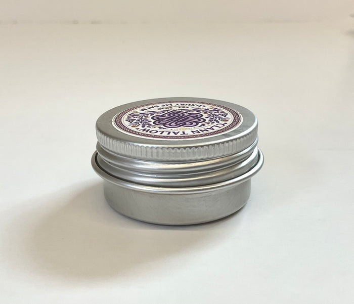 Metal tin with a decorative lid on a white background
