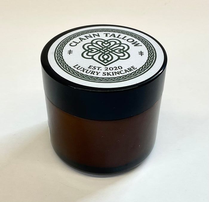 Brownglass  jar with black lid featuring 'Clann Tallow Luxury Skincare' on a white background