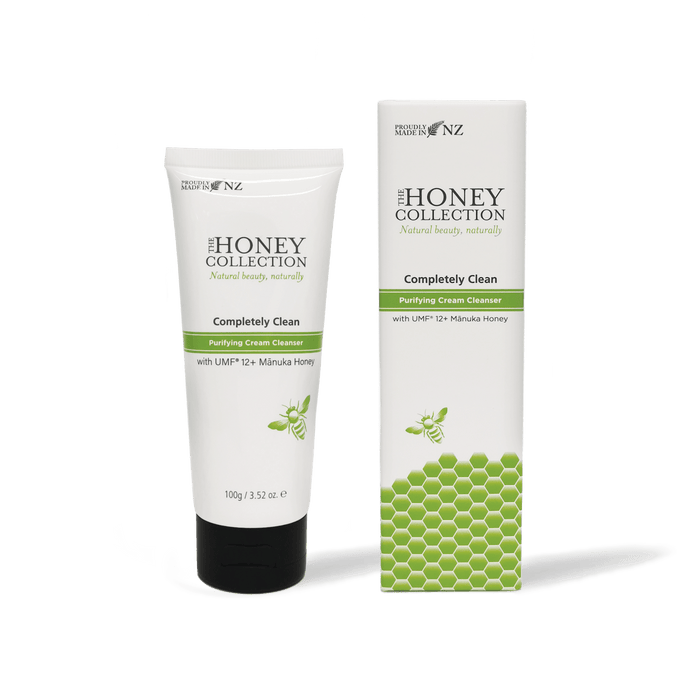 The Honey Collection Completely Clean Purifying Cream Cleanser in a white tube with a flip-top cap, suitable for gentle facial cleansing.