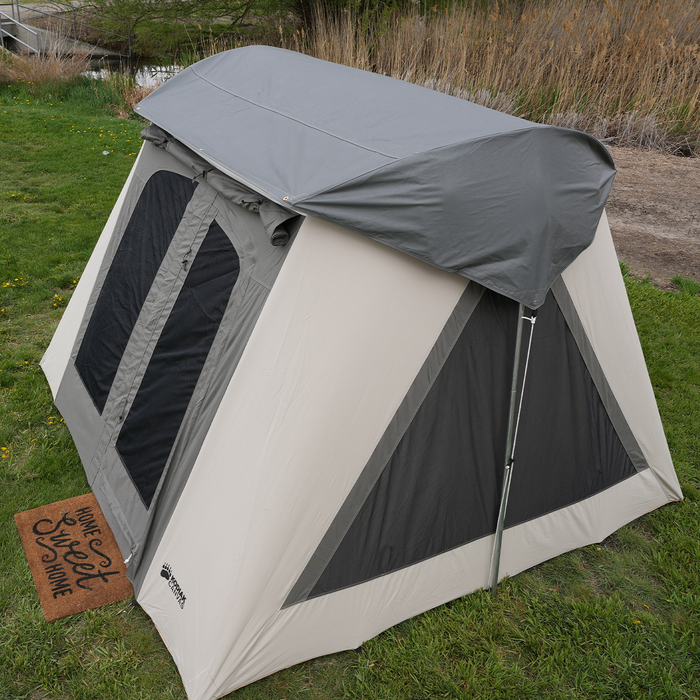 Cream and gray outdoor tent featuring large windows and a weather-resistant canopy, perfect for camping.