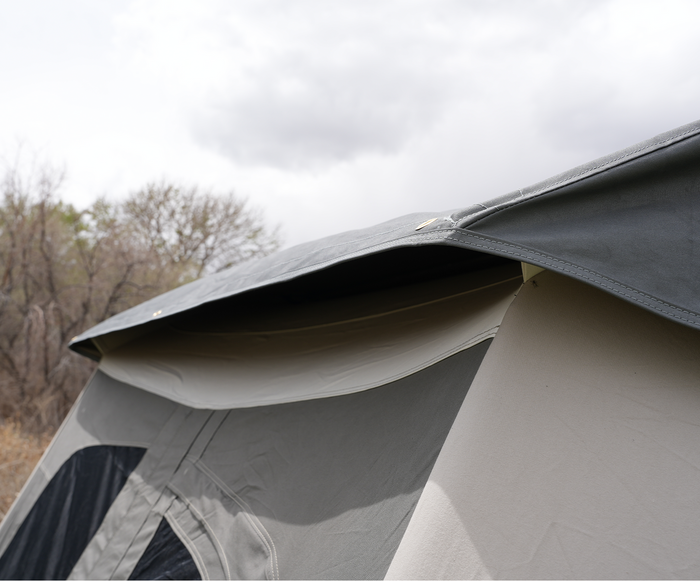 Close-up of a gray camping tent with durable fabric and extended rainfly for weather protection.