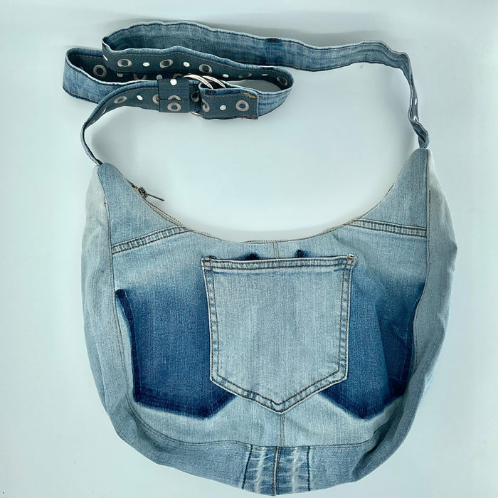 Denim bag with a strap on a white background