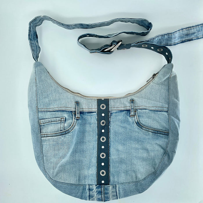 Denim handbag with a strap on a white background
