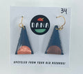 Triangular earrings with bronze and dark grey design on a Dana brand card.