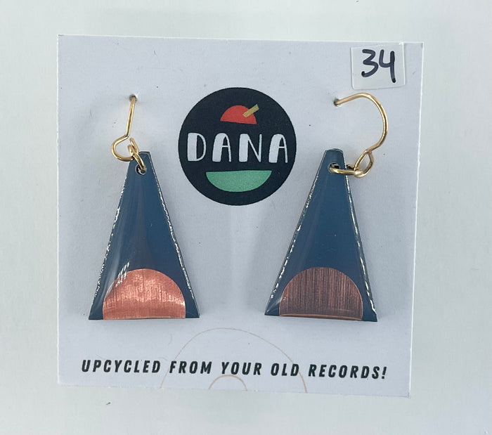 Triangular earrings with bronze and dark grey design on a Dana brand card.