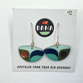 A pair of green boat-shaped earrings made from upcycled vinyl records, displayed on a white card with the Dana brand logo.