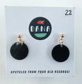 Black circular earrings on a Dana branded card with text about upcycling from old records.