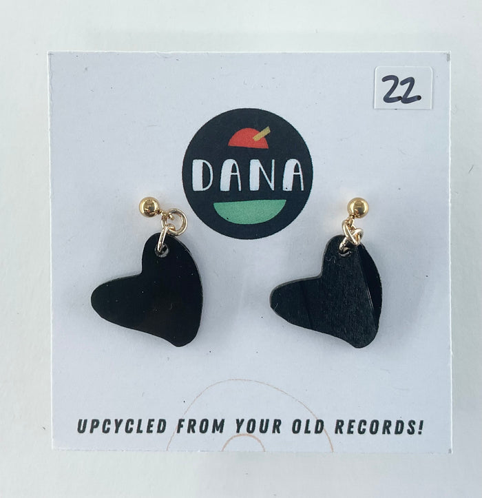 Black heart-shaped earrings on a Dana branded card with 'Upcycled from your old records!' text.