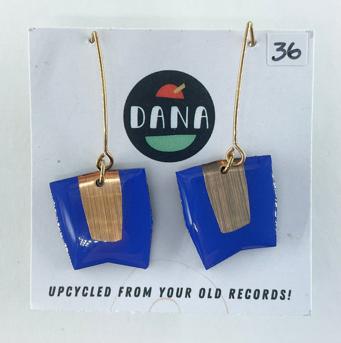 Blue and gold earrings on a card with 'DANA' branding and text about upcycling from old records.