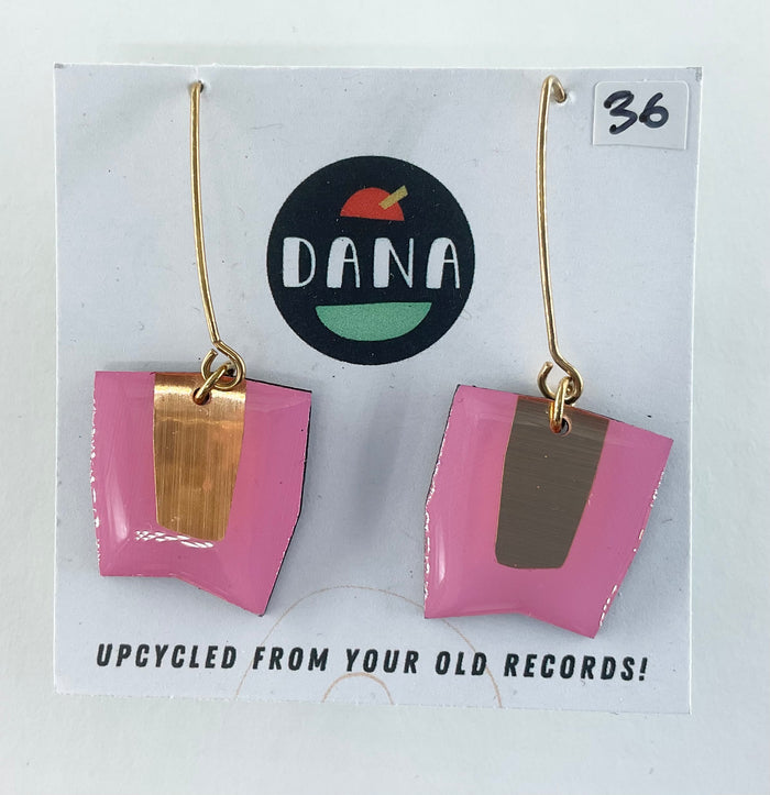 Pink and gold earrings on a card with 'DANA' branding and text about upcycling from old records.