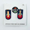 A pair of navy blue, red, turquoise, and gold earrings, displayed on a card with the brand name Dana.