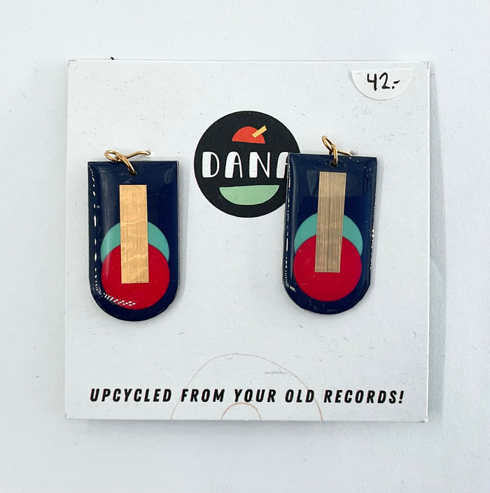 A pair of navy blue, red, turquoise, and gold earrings, displayed on a card with the brand name Dana.