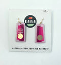 A pair of gold and pink earrings, with the Dana Jewellery brand visible, displayed on a card.