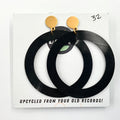 A pair of large black hoop earrings made from upcycled vinyl record, displayed on a white background with the text 'UPCYCLED FROM YOUR OLD RECORDS!'