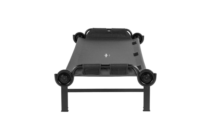 Portable black folding cot with robust metal frame and fabric sleeping surface for camping or guests.