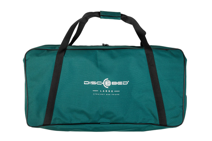 Large green Disc-O-Bed storage bag with black straps and logo, perfect for camping and outdoor activities.