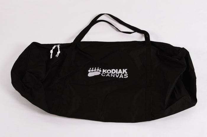 Kodiak Canvas black duffel bag with white logo, durable, spacious design for camping and travel.