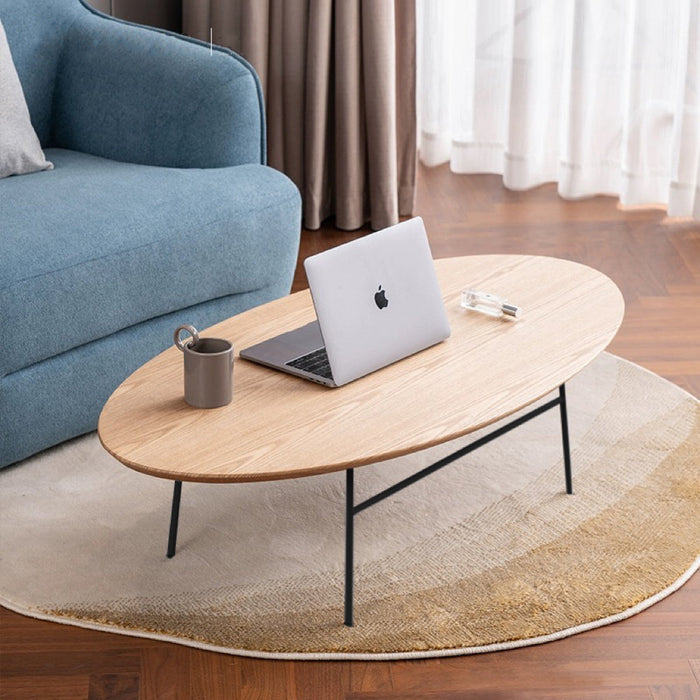 Elegant oval coffee table by sue-e furniture with smooth wooden surface and sleek legs, perfect for modern living rooms.