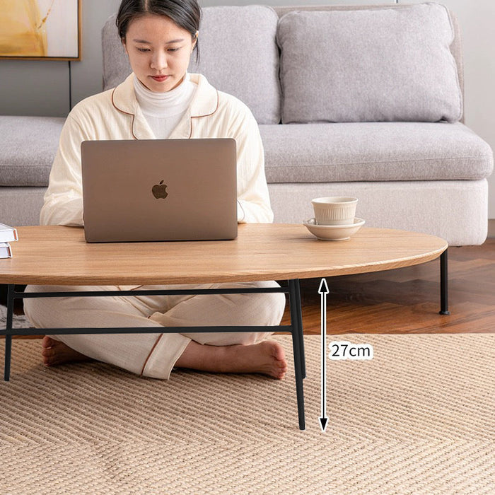 Elegant oval coffee table from sue-e furniture with a sleek wooden finish and modern design, perfect for living room decor.