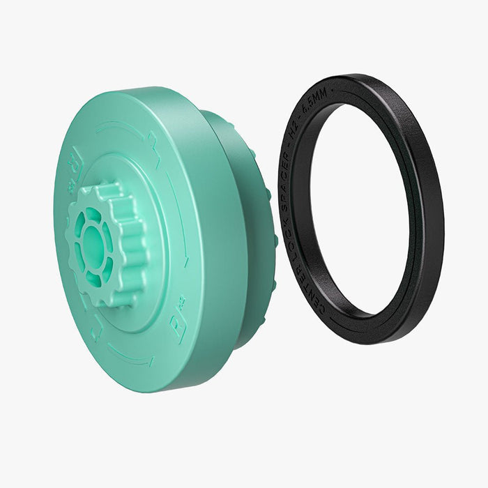 The HALOBLK Store H2-Centerlock Cap-Right, a teal round plastic part with ridges, is displayed beside a flat black circular ring, both shown on a white background.