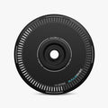 A black, circular HALODISC 2 Replacement Wheel Cover by HALOBLK Store for Tesla Model Y, featuring white edge markings, a central hole, and the words HALOBLK and HALODISC printed on the surface.