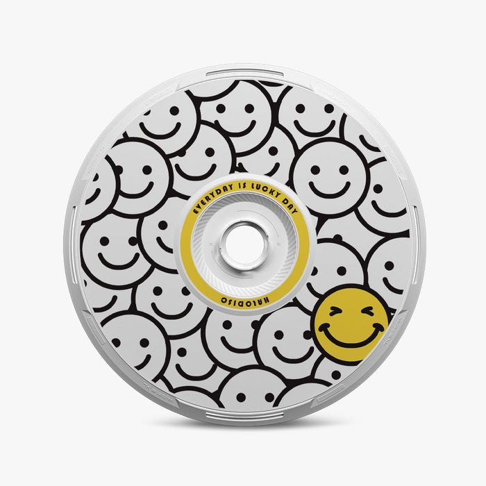 The HALODISC 2 Replacement Wheel Cover for Tesla Model Y Juniper丨Lucky Day by HALOBLK Store features a black and white smiley face pattern with a large yellow smiley in the bottom right and "EVERYDAY IS LUCKY DAY! RINOSDIO" text on the center ring.