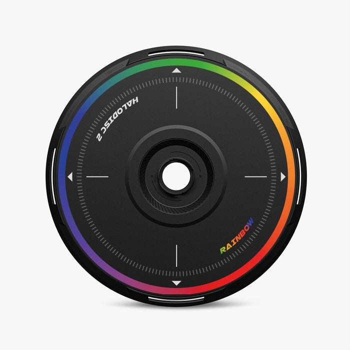 A round, black HALODISC 2 Replacement Wheel Cover by HALOBLK Store for Tesla Model Y features a central hole, white markings, and a rainbow-colored border; “HALO DISC 2” and “RAINBOW” are printed on the surface.