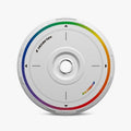 A white HALODISC 2 Replacement Wheel Cover by HALOBLK Store for Tesla Model Y (Rainbow Road), featuring a rainbow edge, labeled "HALODISC 2" and "RAINBOW", with a center hole and four black directional markings.