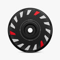 The HALODISC 2 Replacement Wheel Cover for Tesla Model Y Juniper丨Turbo by HALOBLK Store features a black disc with white and red angular accents evenly spaced. "HALO BLK" appears twice along the inner circle, all shown on a plain white background.