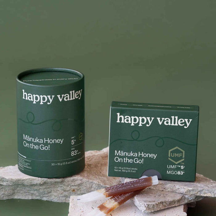 Two on-the-go UMF 5+ Manuka honey sticks from Happy Valley Honey, featuring easy-to-carry packets of natural Manuka honey.