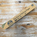 A pack of If You Care Parchment Baking Paper lying on a wooden surface.