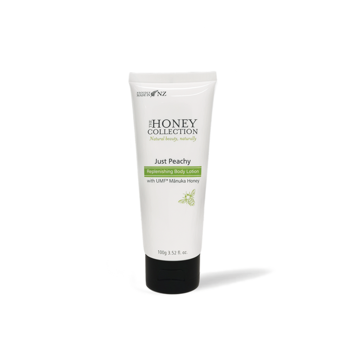 The Honey Collection Just Peachy Replenishing Body Lotion bottle, featuring peach-colored packaging and a pump dispenser.