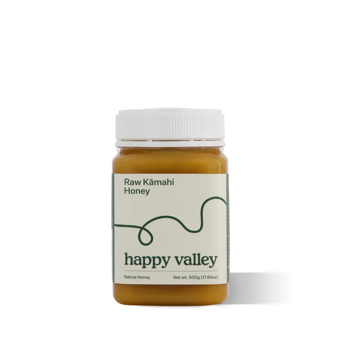 Jar of Happy Valley Honey Kamahi Gourmet & Raw Honey with golden color and honey dipper, showcasing natural and pure honey.