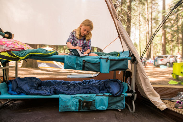 Cozy camping cot for kids in teal with sleeping bags, perfect for outdoor adventures and comfort.
