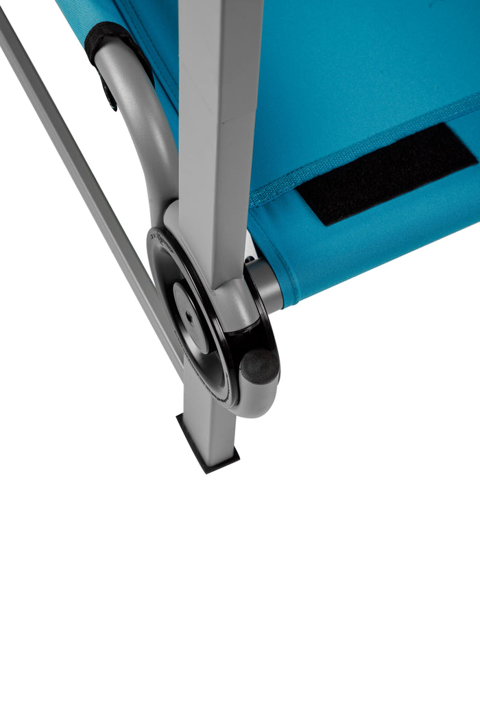 Close-up of a turquoise fabric camping chair with durable aluminum frame and adjustable locking wheels.