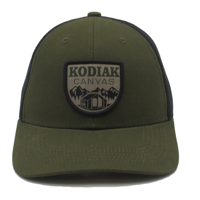 Olive green trucker hat with Kodiak Canvas logo and mountain graphic, made from durable materials.