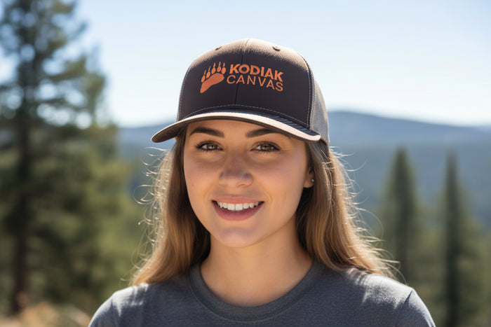 Brown Kodiak Canvas cap with orange logo, perfect for outdoor adventures and casual wear.