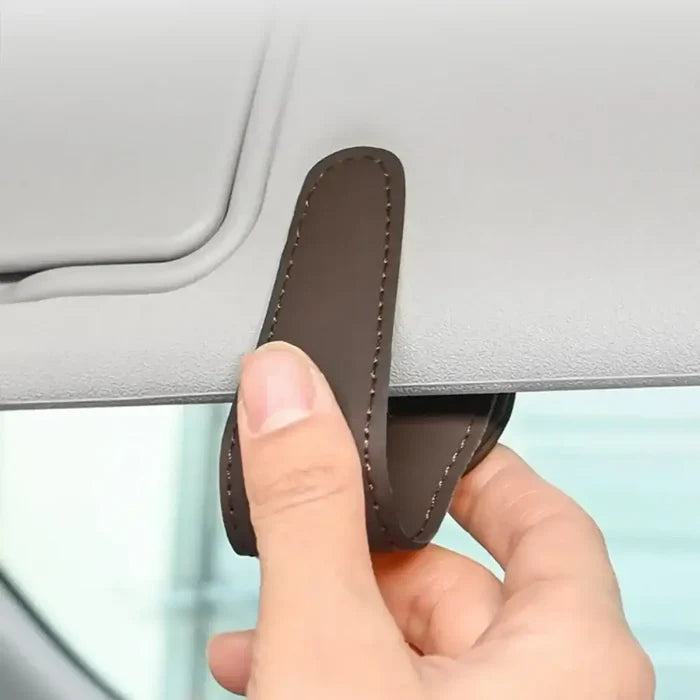 HBC Habicare leather car sunglasses and card holder clip attached to a vehicle interior, showcasing sleek black leather design