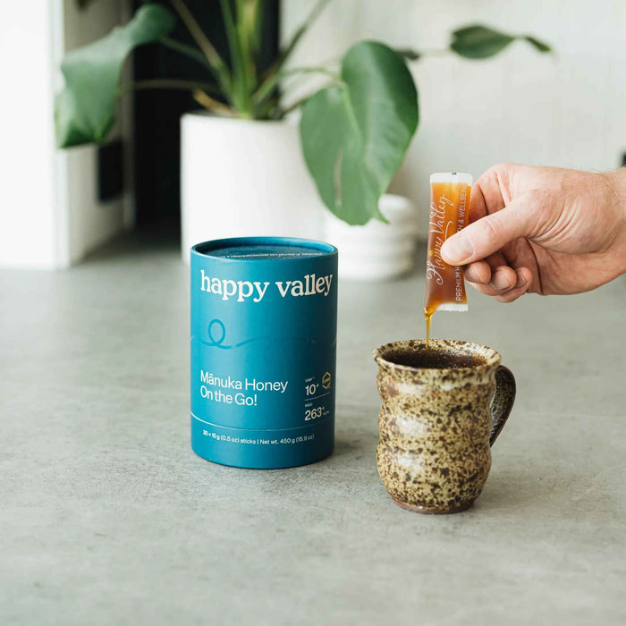 Three Happy Valley Honey Mānuka Honey packets with UMF 10+ honey sticks for on-the-go use, featuring natural golden honey inside.